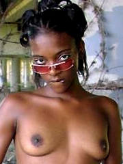 Curly-haired naked black chick posing..