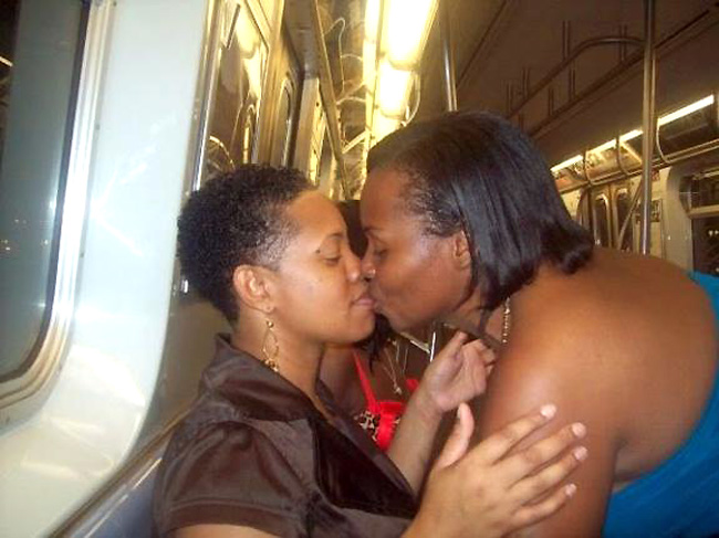 Young African American high school girls kissing in front of ...